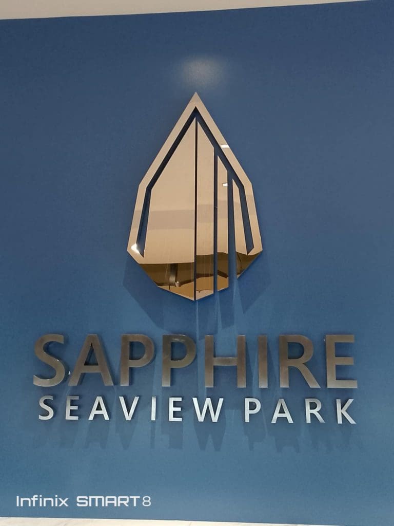 SAPPHIRE SEAVIEW PARK 3D signage for Infinix, blue wall, Makati, silver geometric logo by M&G Global Ads.
