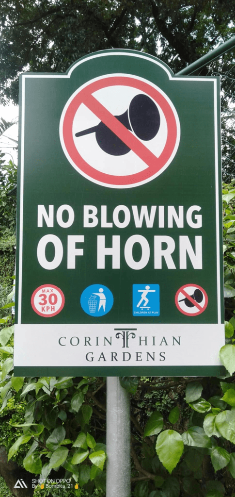Safety signage for Corinthian Gardens in Quezon City: No Blowing of Horn, 30 KPH, no littering or smoking by M&G Global Ads.