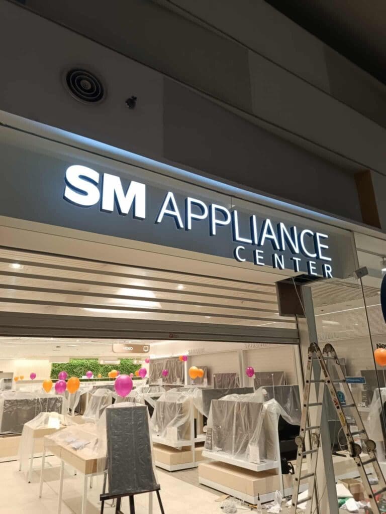 SM Appliance Center acrylic building signage under construction in Metro Manila by sign maker Philippines, M&G Global Ads.