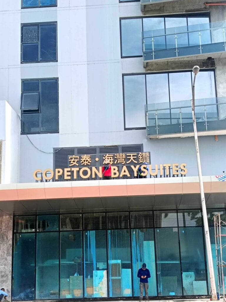Acrylic outdoor building signage for COPETON BAY SUITES with English and Chinese by sign maker Philippines, M&G Global Ads.