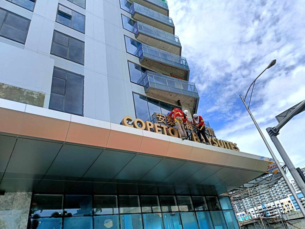 COPETON BAY SUITES building gold signage (brass) with decorative lions, Metro Manila. Sign maker Philippines by M&G Global Ads.