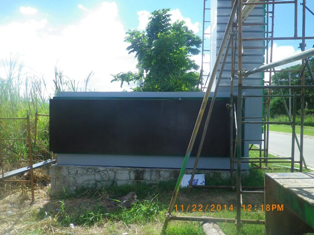 Outdoor pylon acrylic signboard on stone base, roadside, Metro Manila. Sign maker Philippines by M&G Global Ads.