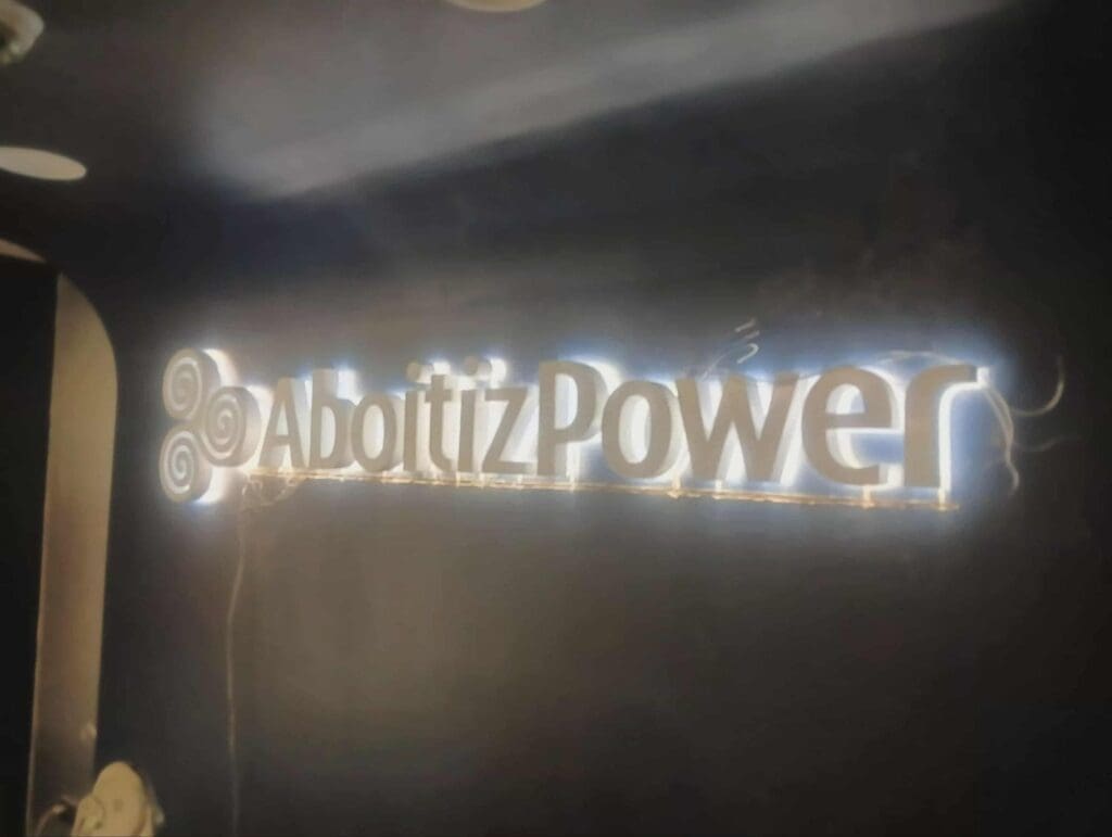 AboitizPower acrylic LED indoor signage with decorative logo, illuminated on dark wall, Metro Manila sign maker Philippines by M&G Global Ads.