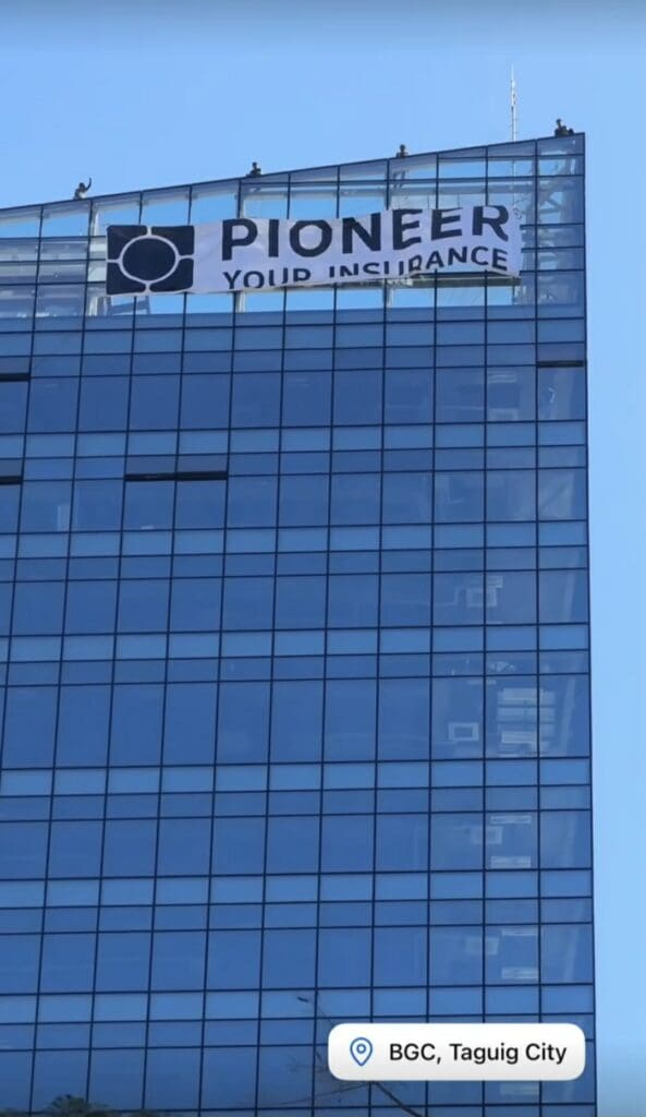 Acrylic building signage for Pioneer Your Insurance on a tall glass office in BGC, Taguig City by sign maker Philippines, M&G Global Ads.
