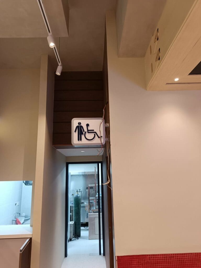 Acrylic indoor restroom wayfinding sign maker Philippines above doorway, male and wheelchair symbols, Metro Manila by M&G Global Ads.