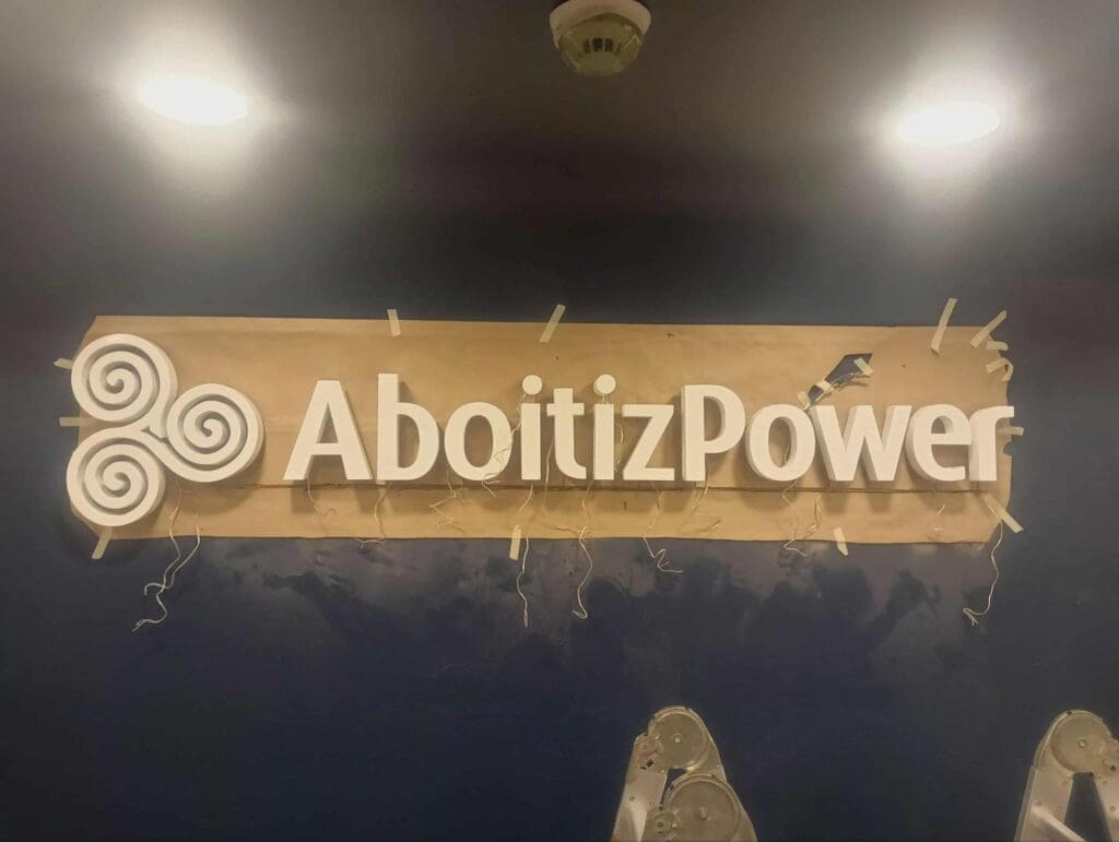Acrylic indoor signage for AboitizPower partially covered, newly installed in the Philippines by sign maker Philippines, M&G Global Ads.