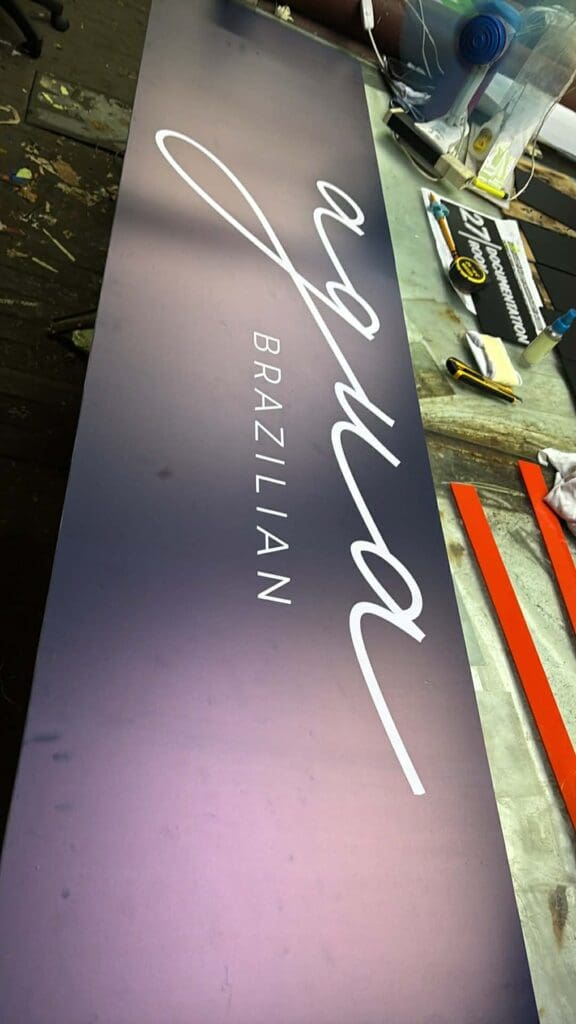 Acrylic indoor signage for aqua BRAZILIAN with gradient purple background by sign maker Philippines, by M&G Global Ads.