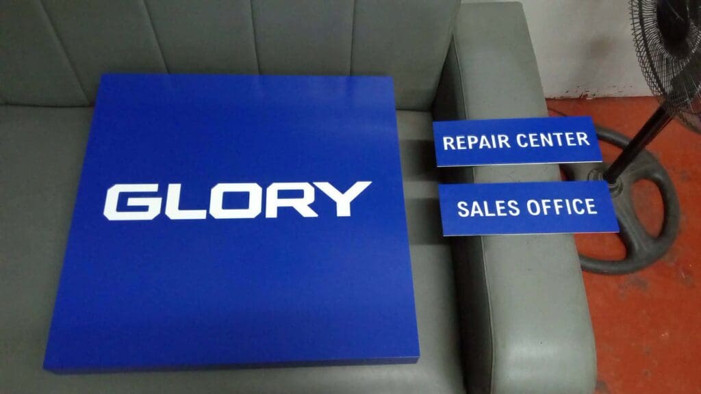 Acrylic indoor signage for GLORY, REPAIR CENTER, SALES OFFICE on sofa in Metro Manila by sign maker Philippines M&G Global Ads.