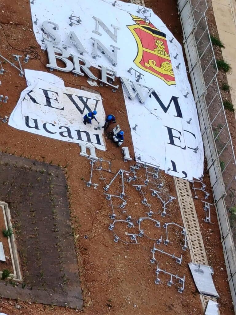 Acrylic outdoor building sign installation in Metro Manila by sign maker Philippines, by M&G Global Ads.