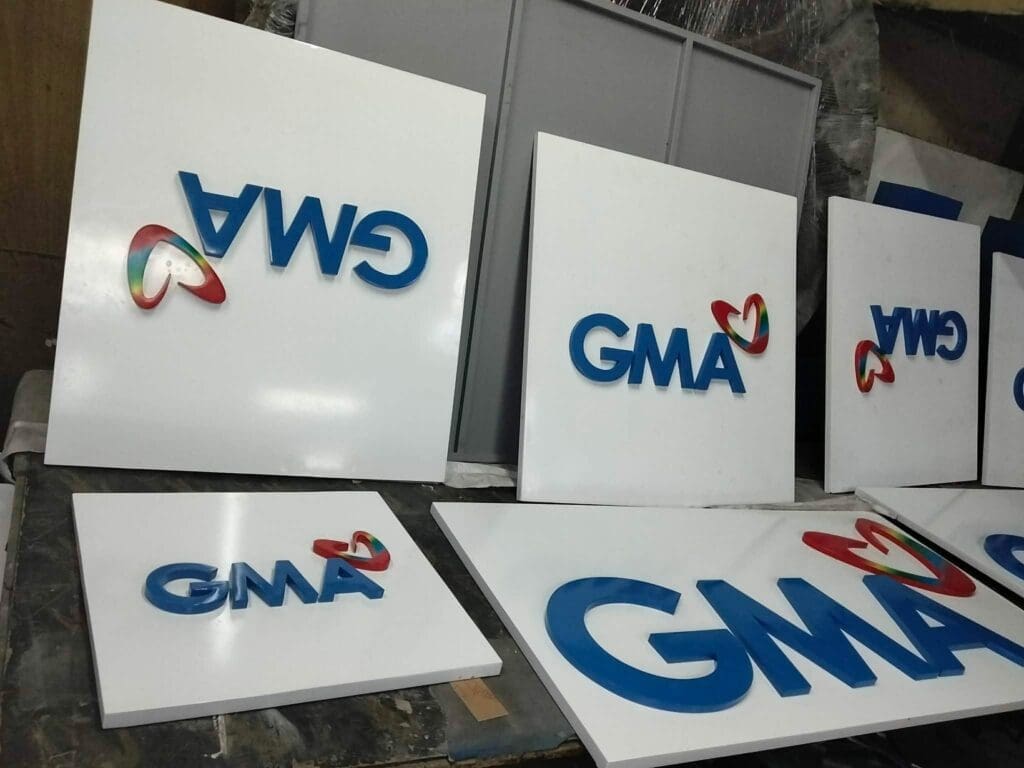 Acrylic signboards with blue GMA logo and heart design, Metro Manila, sign maker Philippines by M&G Global Ads.