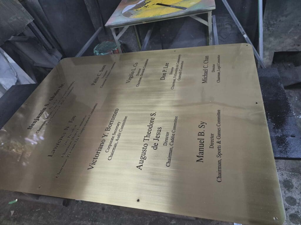 Brass engraved plaque signage for committee chairpersons, workshop view, sign maker Philippines by M&G Global Ads.