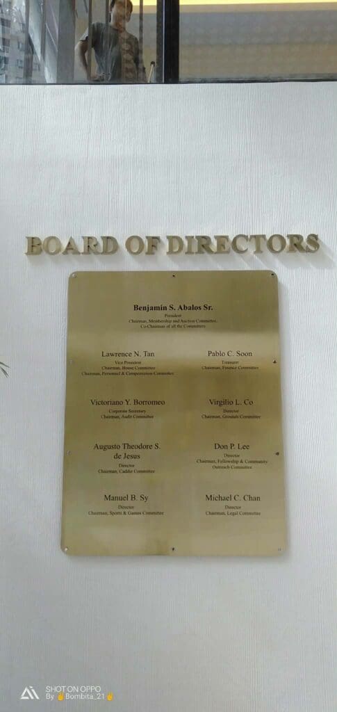 Brass indoor Board of Directors signage listing names and titles, reflection visible. Sign maker Philippines. By M&G Global Ads.