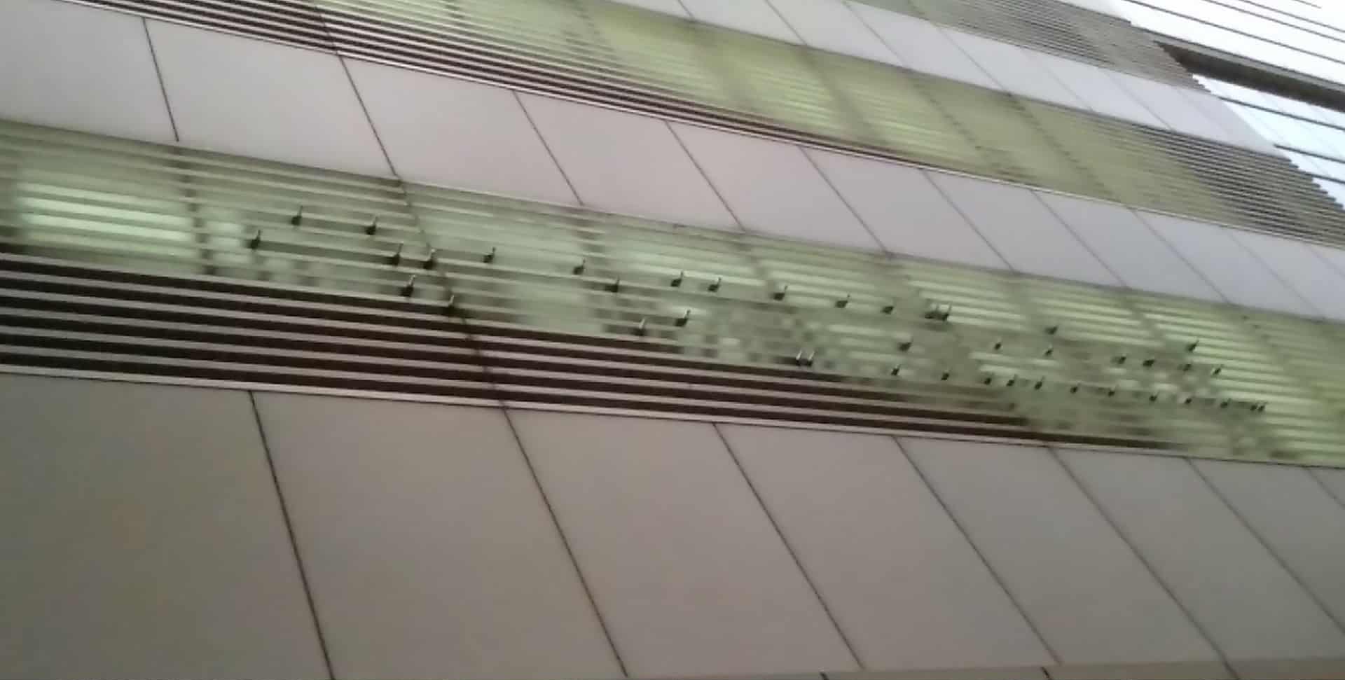 Building exterior with aluminum horizontal panels, narrow glass windows, outdoor signage; sign maker Philippines by M&G Global Ads.