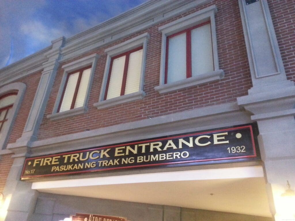 Building facade with aluminum building signage FIRE TRUCK ENTRANCE, red windows, brick walls—sign maker Philippines by M&G Global Ads.