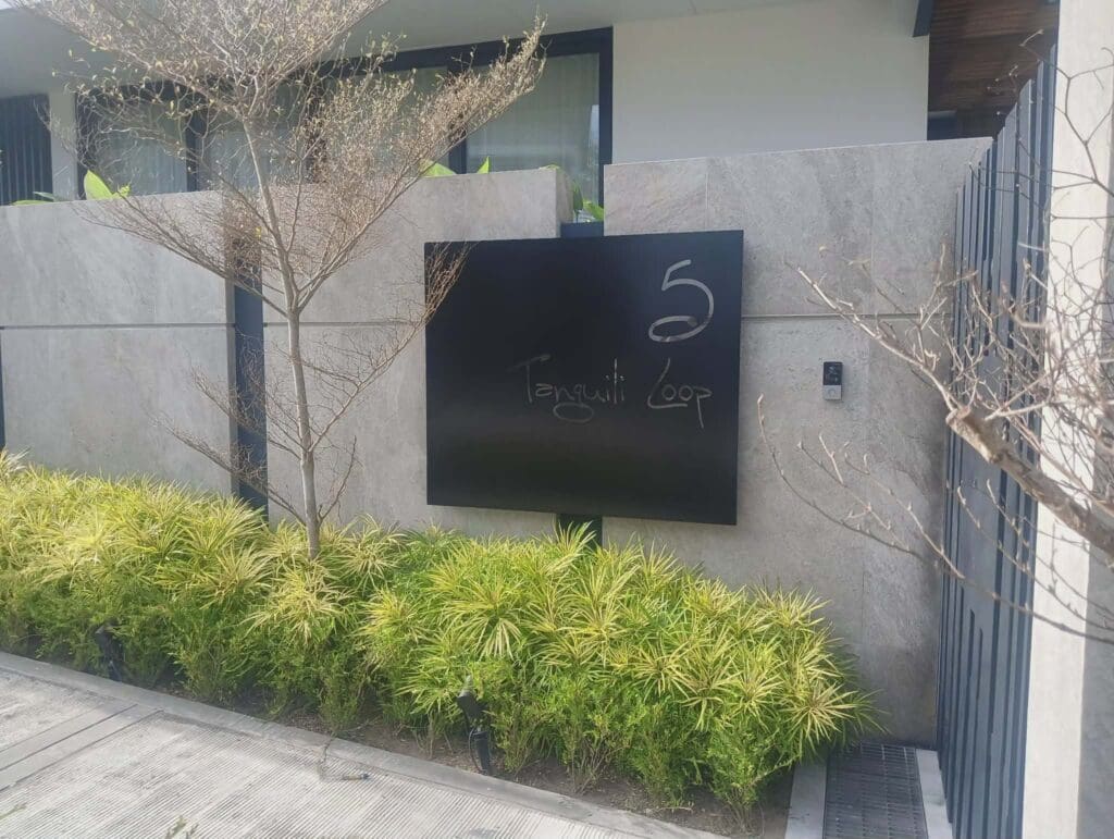 Building outdoor acrylic signage for 5 Tranquil Loop on gray concrete wall, Metro Manila, sign maker Philippines by M&G Global Ads.