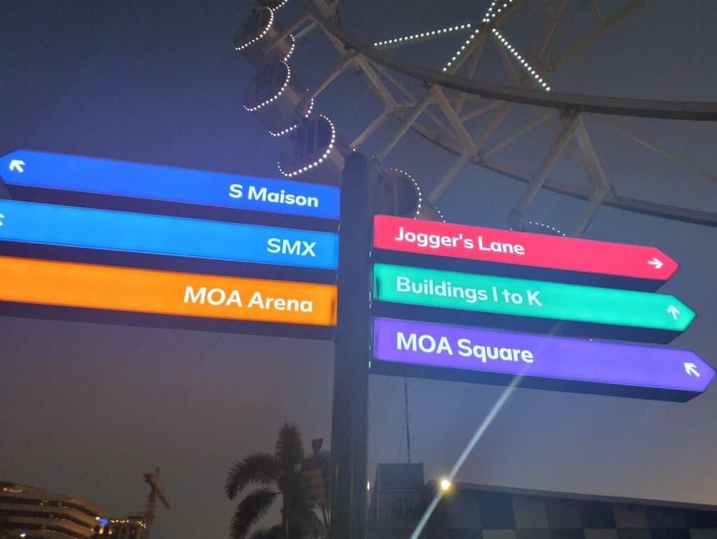 Colorful outdoor wayfinding signages at night in MOA, Metro Manila by sign maker Philippines M&G Global Ads.