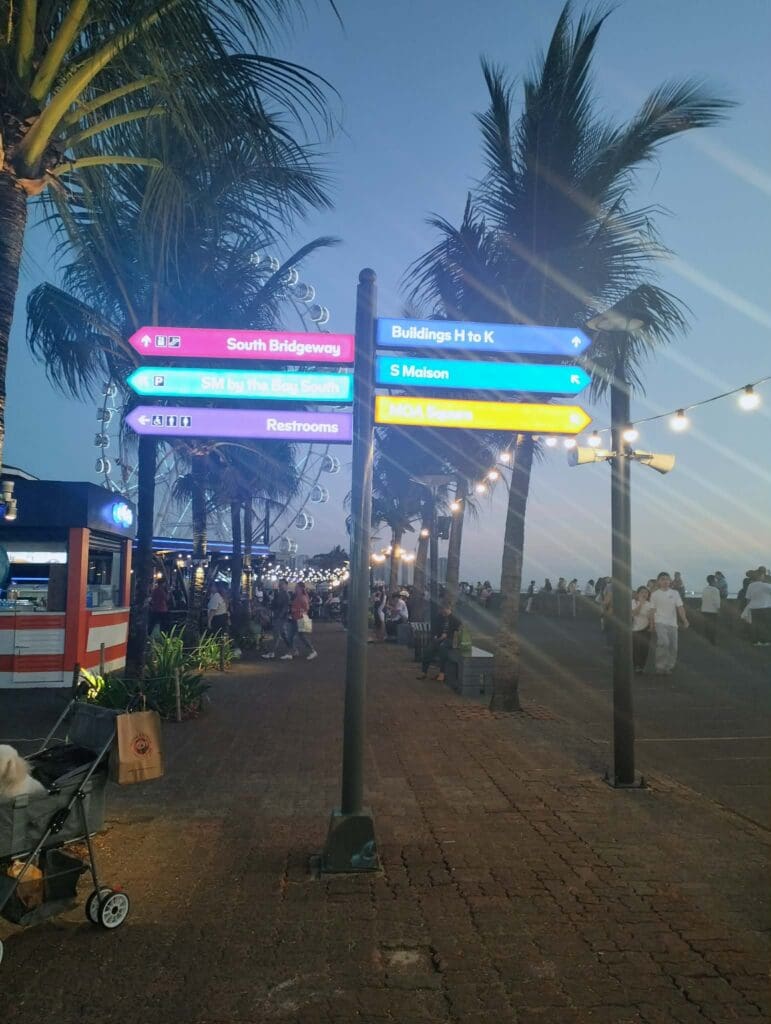 Colorful wayfinding signage, outdoor aluminum signpost at palm promenade, Metro Manila. Sign maker Philippines by M&G Global Ads.
