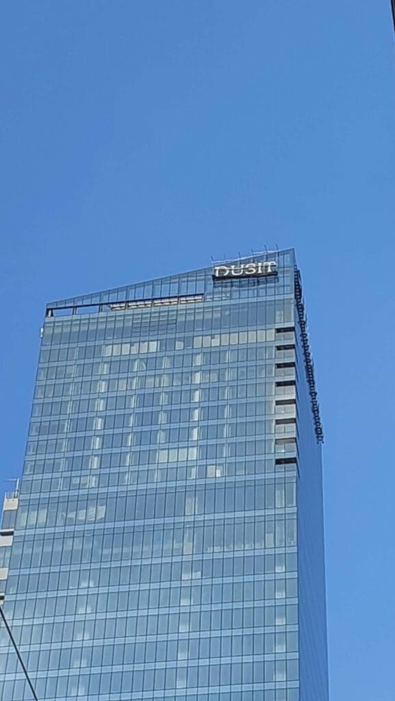 Dusit outdoor building LED signage on a modern glass skyscraper in Philippines by sign maker Philippines, M&G Global Ads.