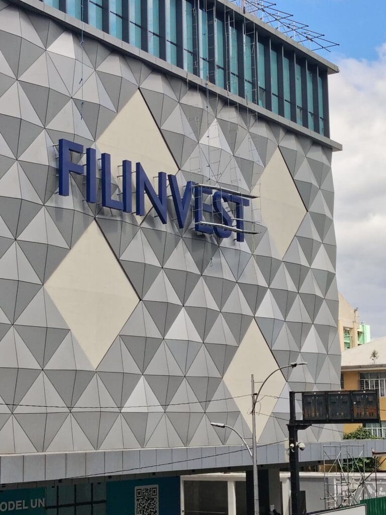 FILINVEST outdoor building acrylic signage on a modern facade, Metro Manila. Sign maker Philippines by M&G Global Ads.