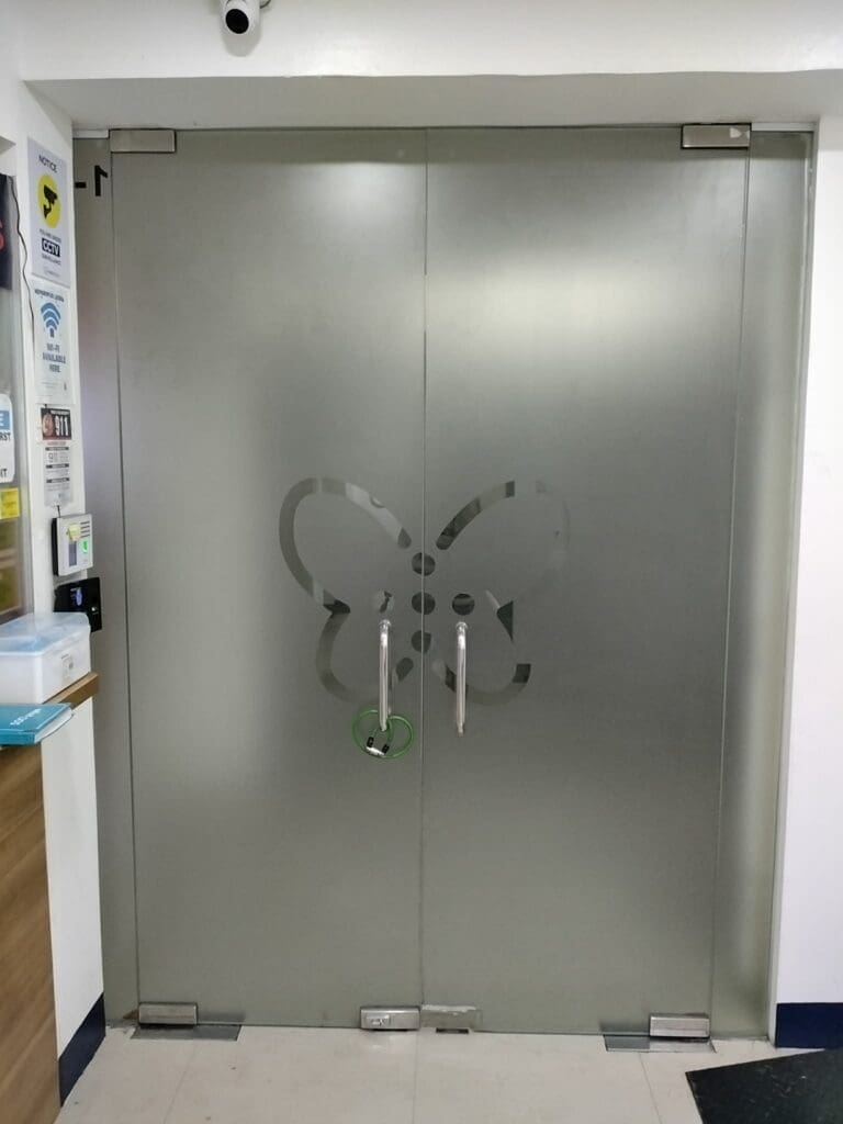 Frosted sticker glass doors with silver handles, butterfly design, indoor hallway signage, Metro Manila sign maker Philippines by M&G Global Ads.