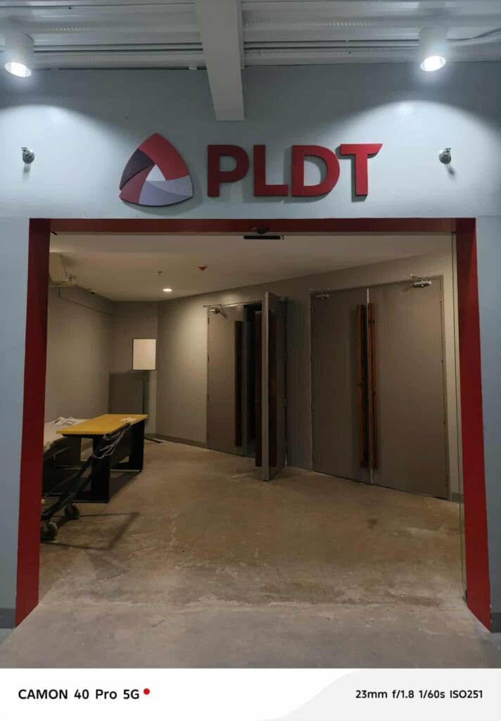 Hallway entrance with red acrylic PLDT office sign, indoor signage, Metro Manila, sign maker Philippines by M&G Global Ads.