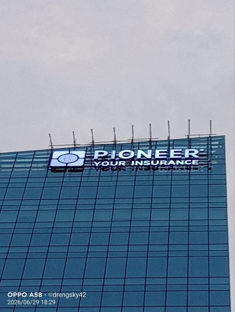 Illuminated outdoor building LED signage for Pioneer Your Insurance on tall glass building, Metro Manila, sign maker Philippines by M&G Global Ads.