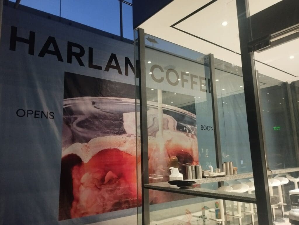 Indoor acrylic banner signage for Harlan Coffee on glass wall, Metro Manila, by sign maker Philippines M&G Global Ads.