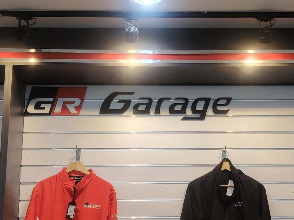 Indoor acrylic building signage for GR Garage above red and black jackets, Metro Manila, by sign maker Philippines M&G Global Ads.