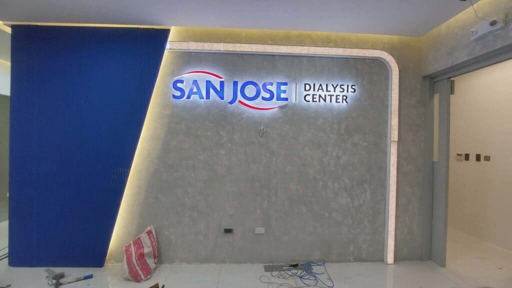 Indoor acrylic LED signage for San Jose Dialysis Center, white wall, construction phase, sign maker Philippines by M&G Global Ads.