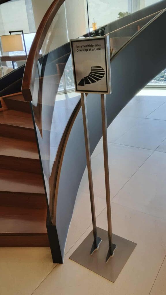 Indoor acrylic wayfinding sign near a curved staircase, Metro Manila, sign maker Philippines by M&G Global Ads.