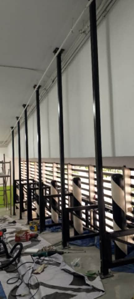 Indoor building signage with black metal poles and striped barriers in Metro Manila, sign maker Philippines by M&G Global Ads.