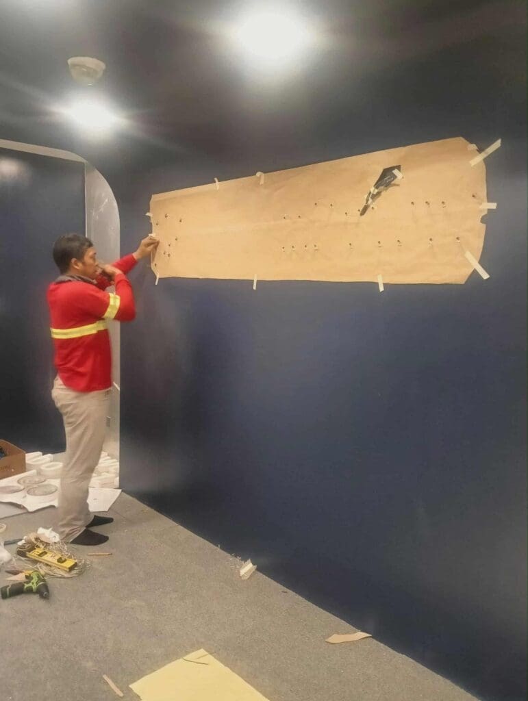 Indoor mural installation with brown paper template, dark blue wall, Metro Manila, by sign maker Philippines M&G Global Ads.
