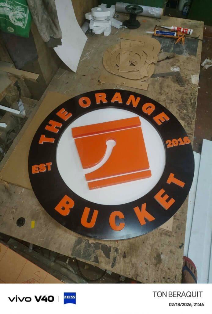 Indoor round acrylic signage for The Orange Bucket, Metro Manila, sign maker Philippines by M&G Global Ads.