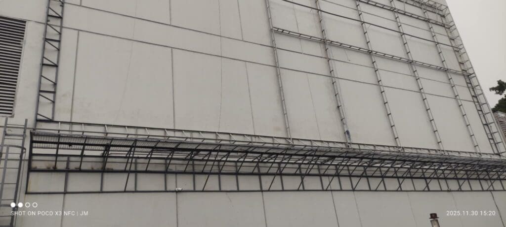 Large industrial building with metal beams, ladders, outdoor building signage in Metro Manila by sign maker Philippines by M&G Global Ads.