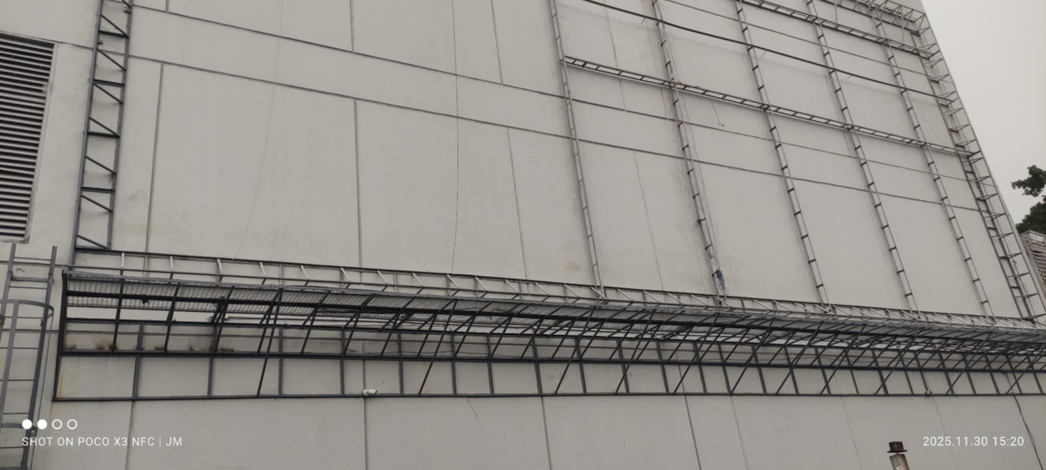 Large industrial building with metal beams, ladders, outdoor building signage in Metro Manila by sign maker Philippines by M&G Global Ads.