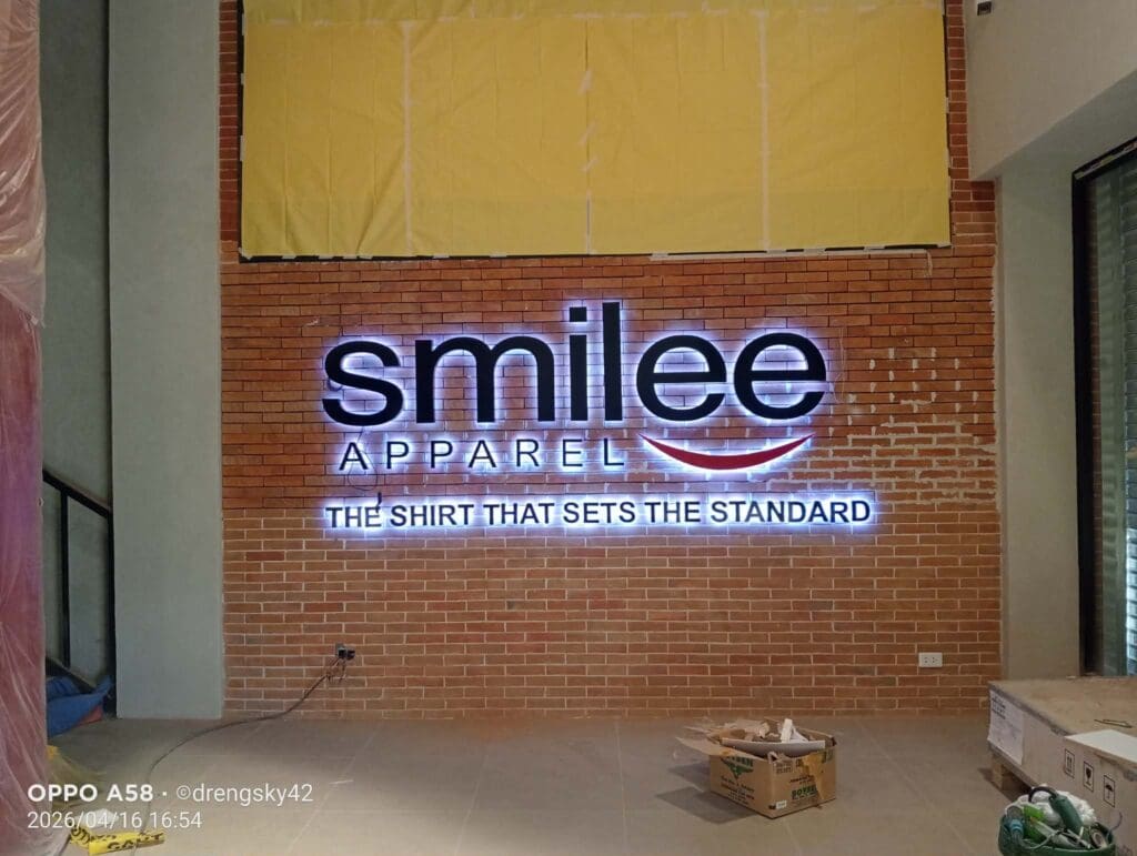 LED acrylic illuminated signage for Smilee Apparel on a brick wall, Metro Manila, sign maker Philippines by M&G Global Ads.