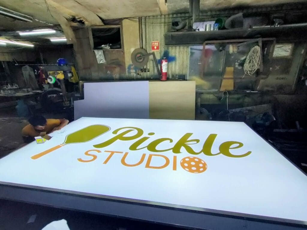LED acrylic indoor signage for Pickle Studio with green paddle and orange icon, sign maker Philippines by M&G Global Ads.