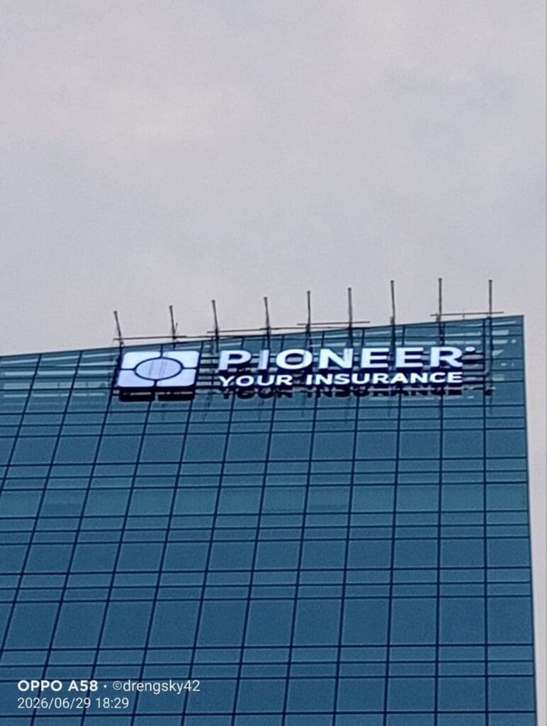 LED building signage for Pioneer Your Insurance on a glass office in Metro Manila, sign maker Philippines by M&G Global Ads.