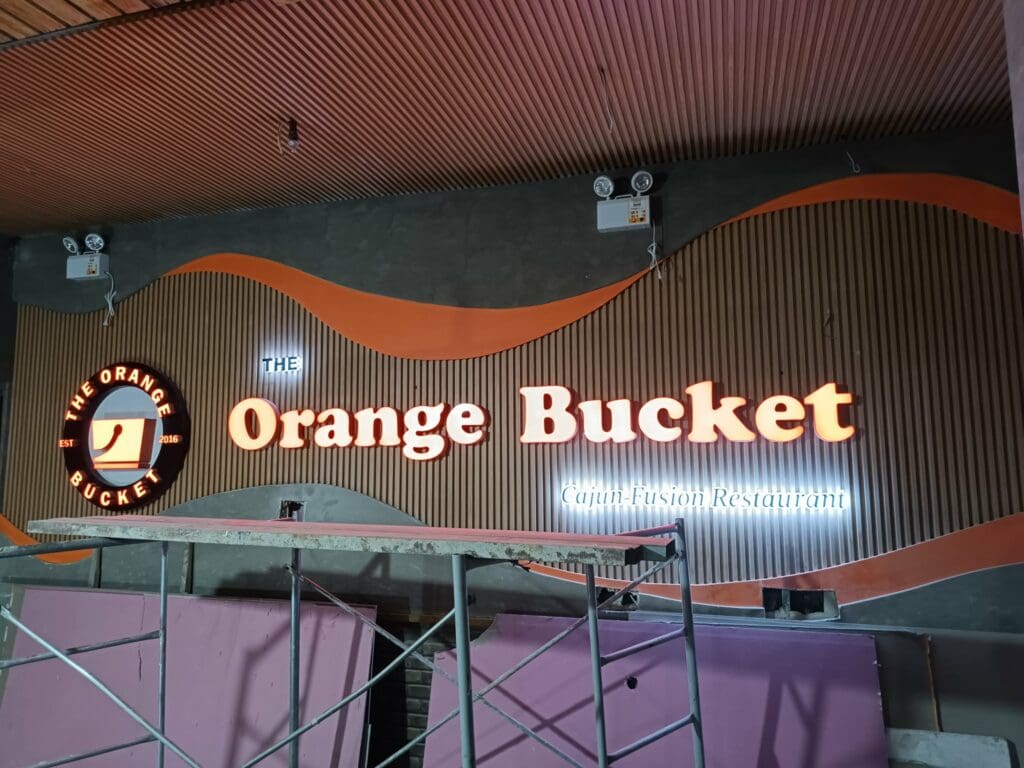 LED illuminated indoor restaurant sign for The Orange Bucket, wood paneling, Metro Manila, sign maker Philippines by M&G Global Ads.