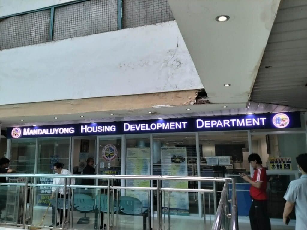 Mandaluyong Housing Development office with bright building signage, glass windows, Metro Manila sign maker Philippines by M&G Global Ads.