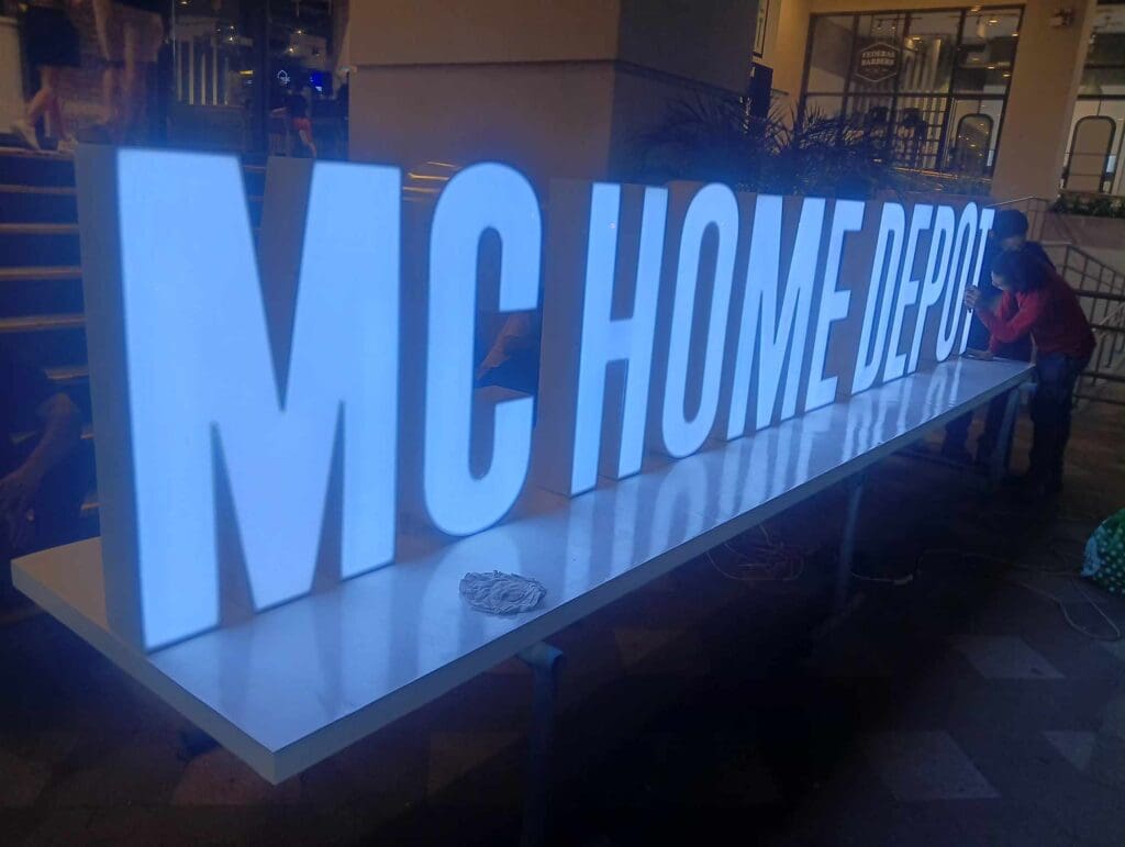 MC HOME DEPOT outdoor LED acrylic signage with visible wiring at night in Metro Manila by sign maker Philippines, by M&G Global Ads.