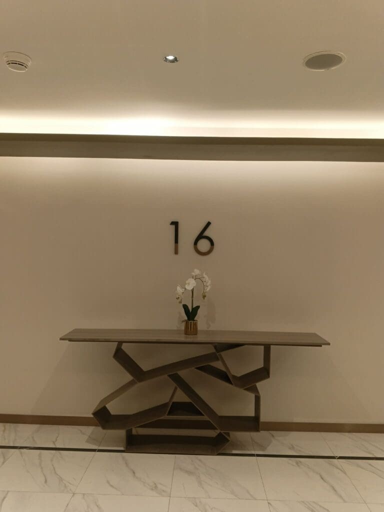Modern hallway in Metro Manila with stainless steel room number 16 wall signage, sign maker Philippines, by M&G Global Ads.