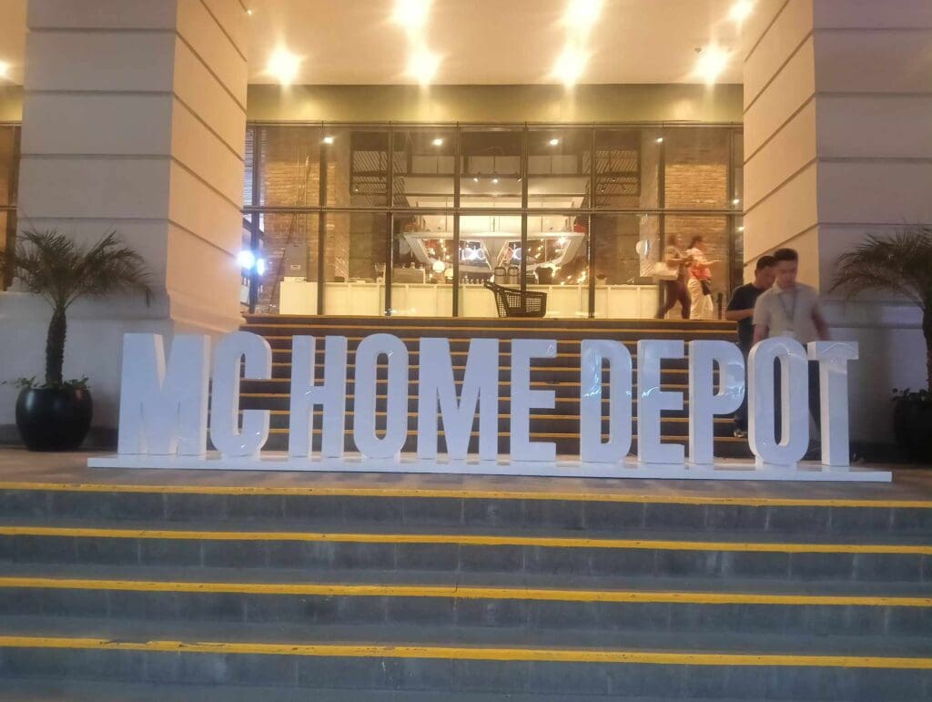Acrylic building signage for MC HOME DEPOT, Metro Manila. Large white letters on steps. sign maker Philippines by M&G Global Ads.