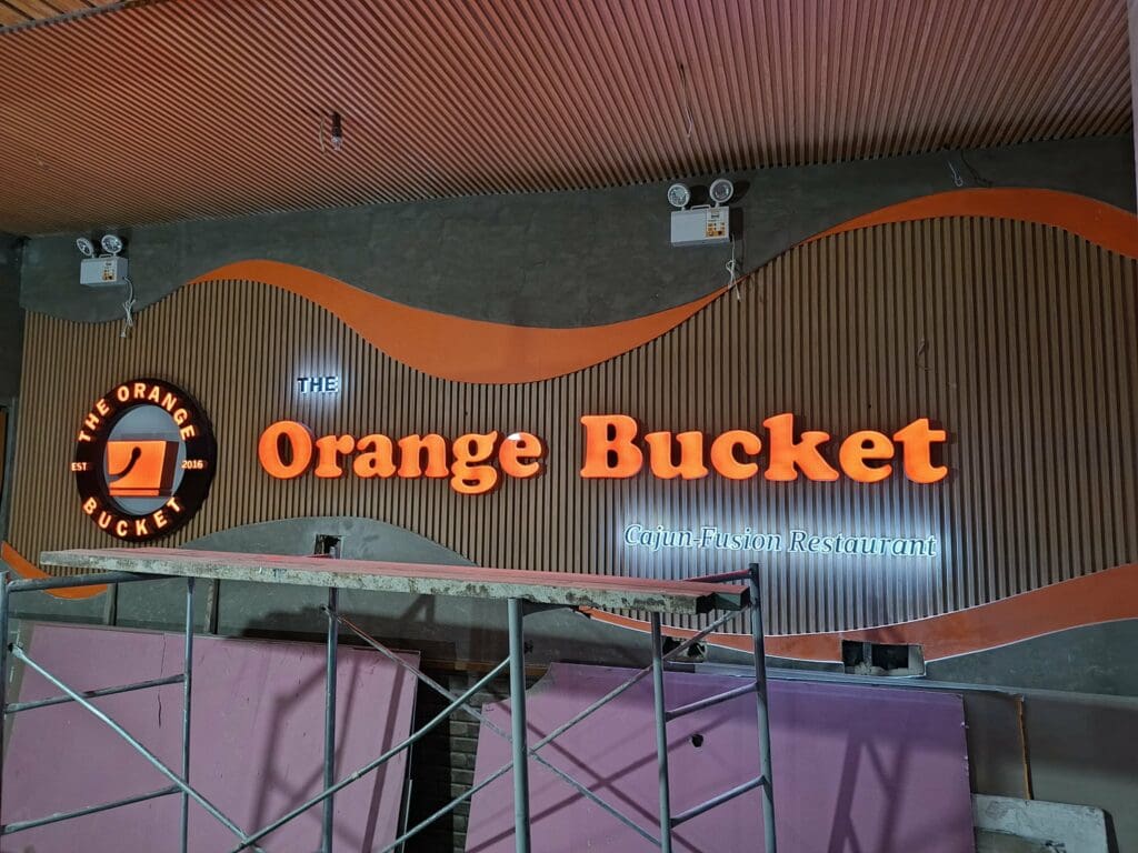 Neon acrylic building signage for The Orange Bucket Cajun Fusion Restaurant, Metro Manila, sign maker Philippines by M&G Global Ads.