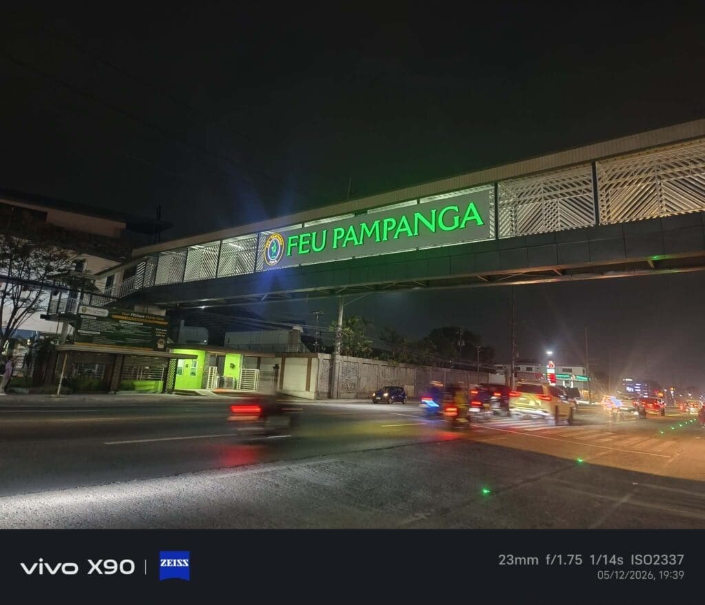 Night view of acrylic LED FEU Pampanga signage, pedestrian overpass, Pampanga street; sign maker Philippines by M&G Global Ads.