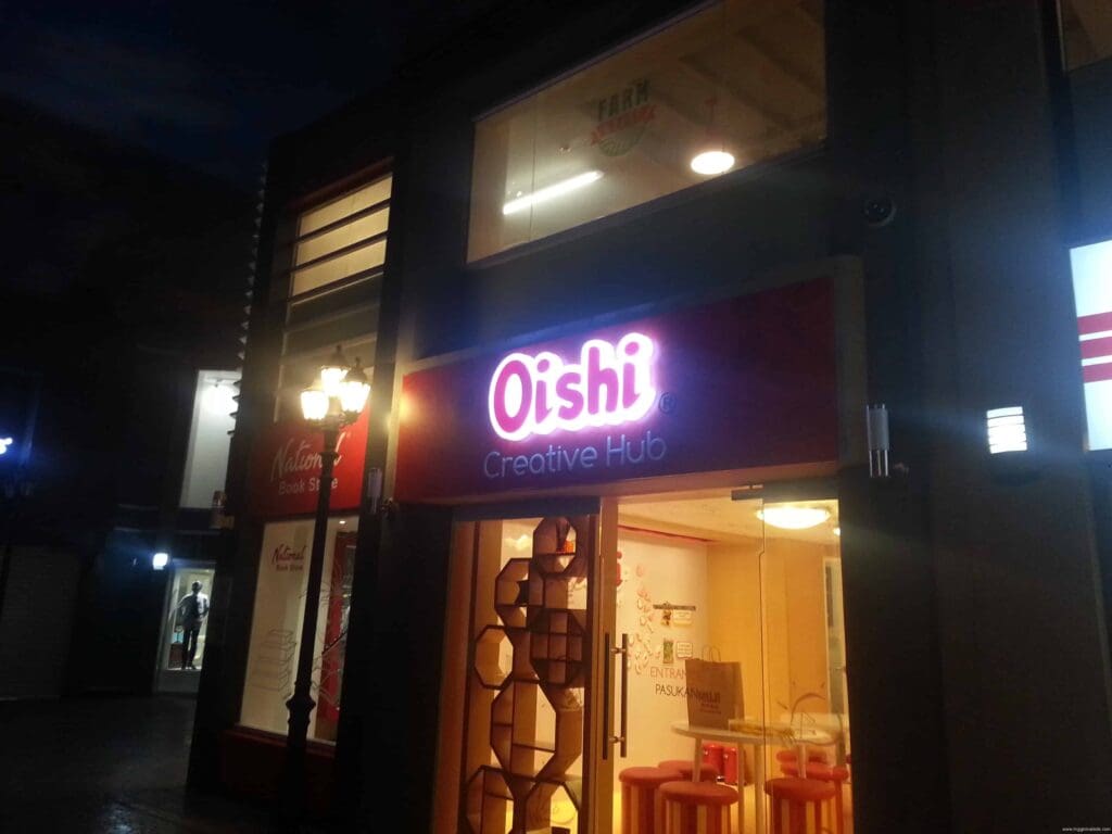 Oishi Creative Hub acrylic building signage, illuminated at night in Metro Manila, sign maker Philippines by M&G Global Ads.