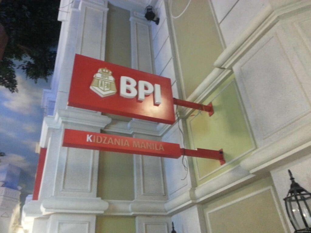 Outdoor acrylic building signage for KidZania Manila, red BPL signs on beige wall, sign maker Philippines by M&G Global Ads.