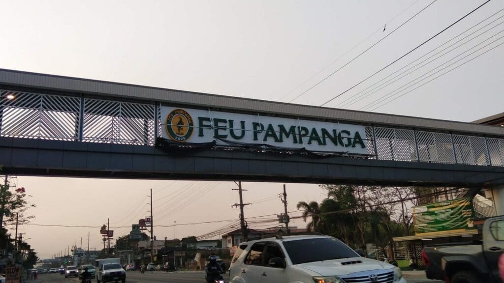 Outdoor building signage, FEU Pampanga acrylic sign on pedestrian overpass in Pampanga, by sign maker Philippines M&G Global Ads.
