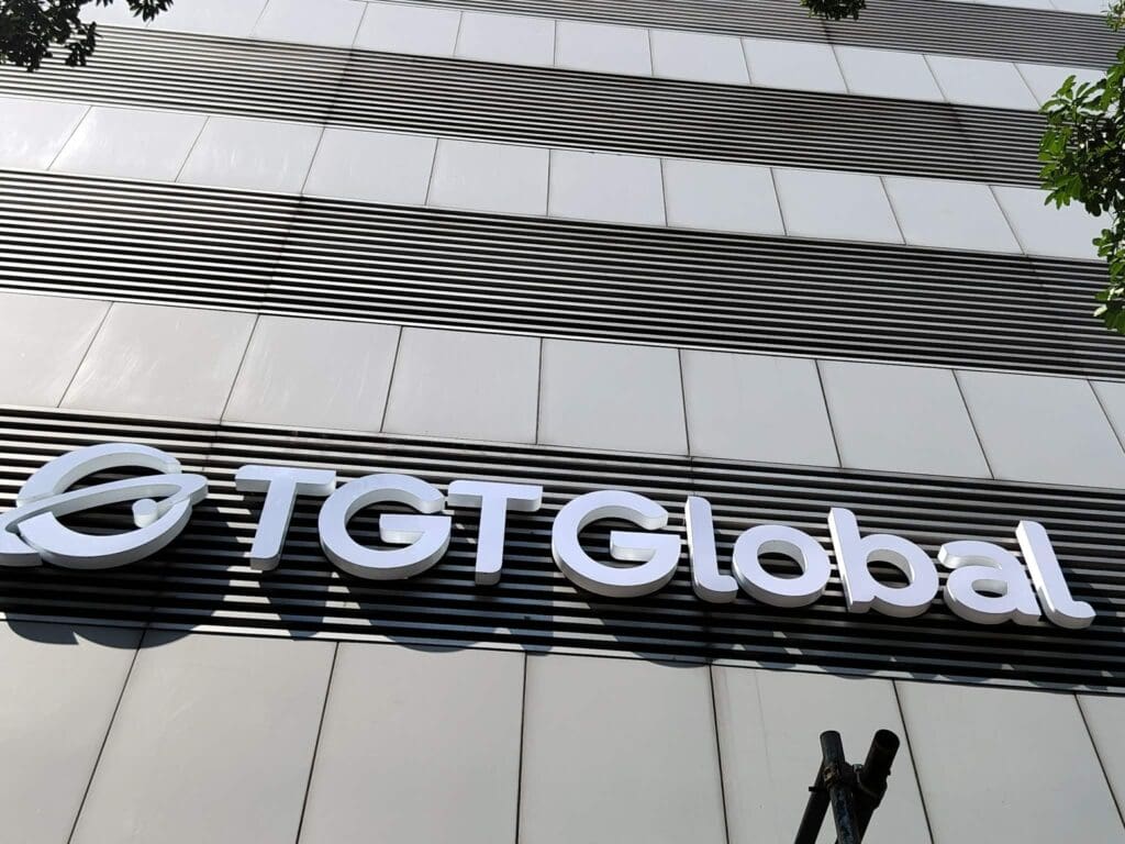 Outdoor building signage with acrylic letters spelling TGT Global, circular logo, Metro Manila, sign maker Philippines by M&G Global Ads.