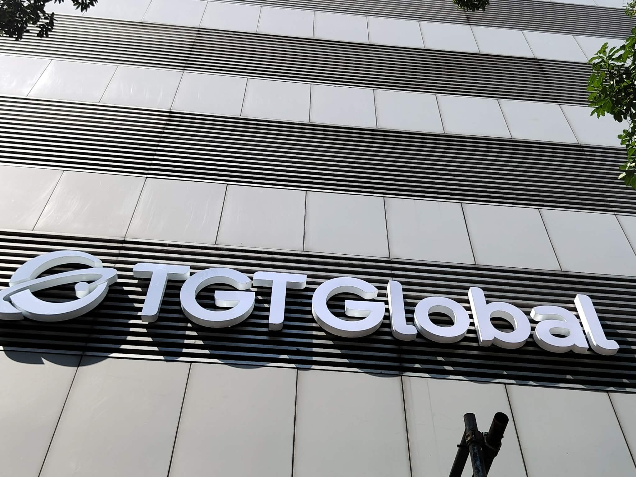 Outdoor building signage with acrylic letters spelling TGT Global, circular logo, Metro Manila, sign maker Philippines by M&G Global Ads.